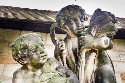 Close-up of angel statue against clear sky