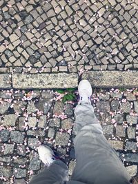 Low section of man standing on footpath