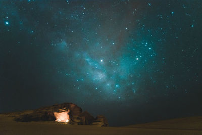 Scenic view of landscape against star field