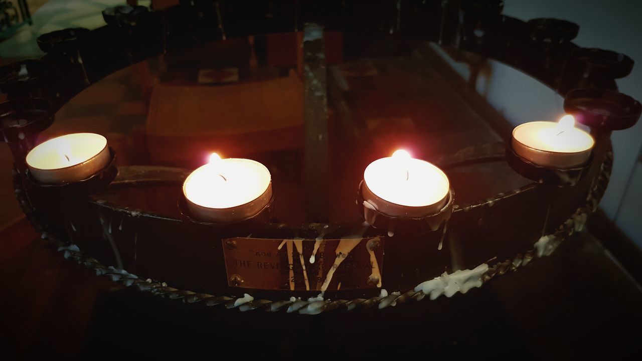 CLOSE-UP OF LIT CANDLE