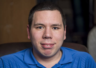 Close-up portrait of smiling young man at home