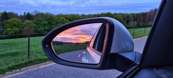 Reflection of road on side-view mirror of car