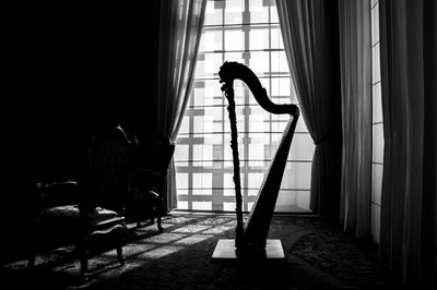 Woman standing by window at home