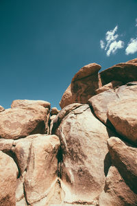 Low angle view of rock formation against sky