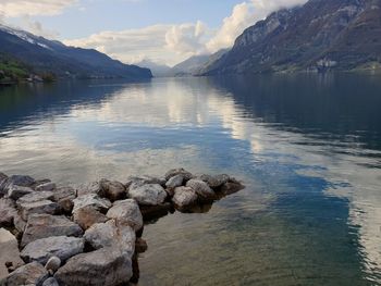 Scenic view of lake and mountains against sky