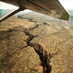 Scenic view of landscape seen through airplane window