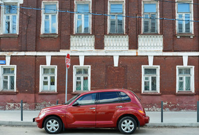 Vintage car on street against building in city