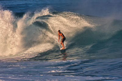 Full length of shirtless man in sea