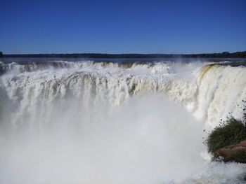 Scenic view of waterfall against clear sky