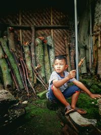 Portrait of boy sitting outdoors