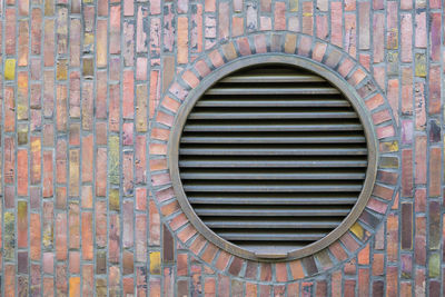 Circular ventilation exhaust vents in stone wall