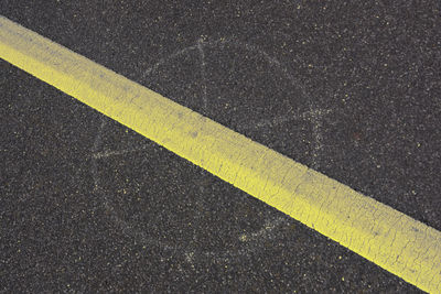 High angle view of yellow marking on road
