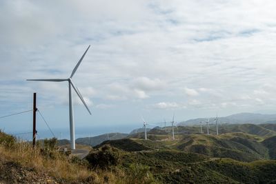 Windmill on field against sky