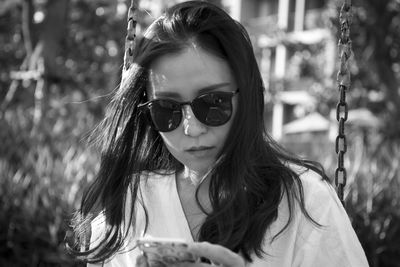 Portrait of young woman wearing sunglasses