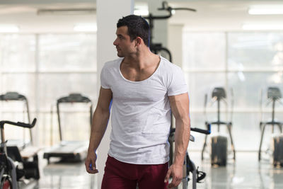 Muscular man standing in gym