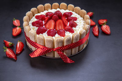 Close-up of strawberries on table against black background