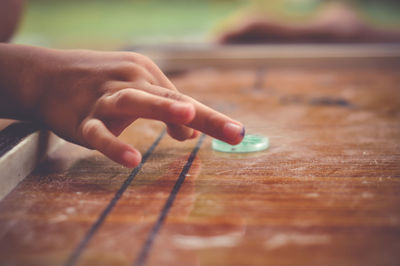 Close-up of hand holding table