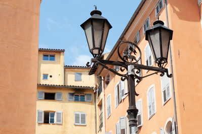 Low angle view of street light against building