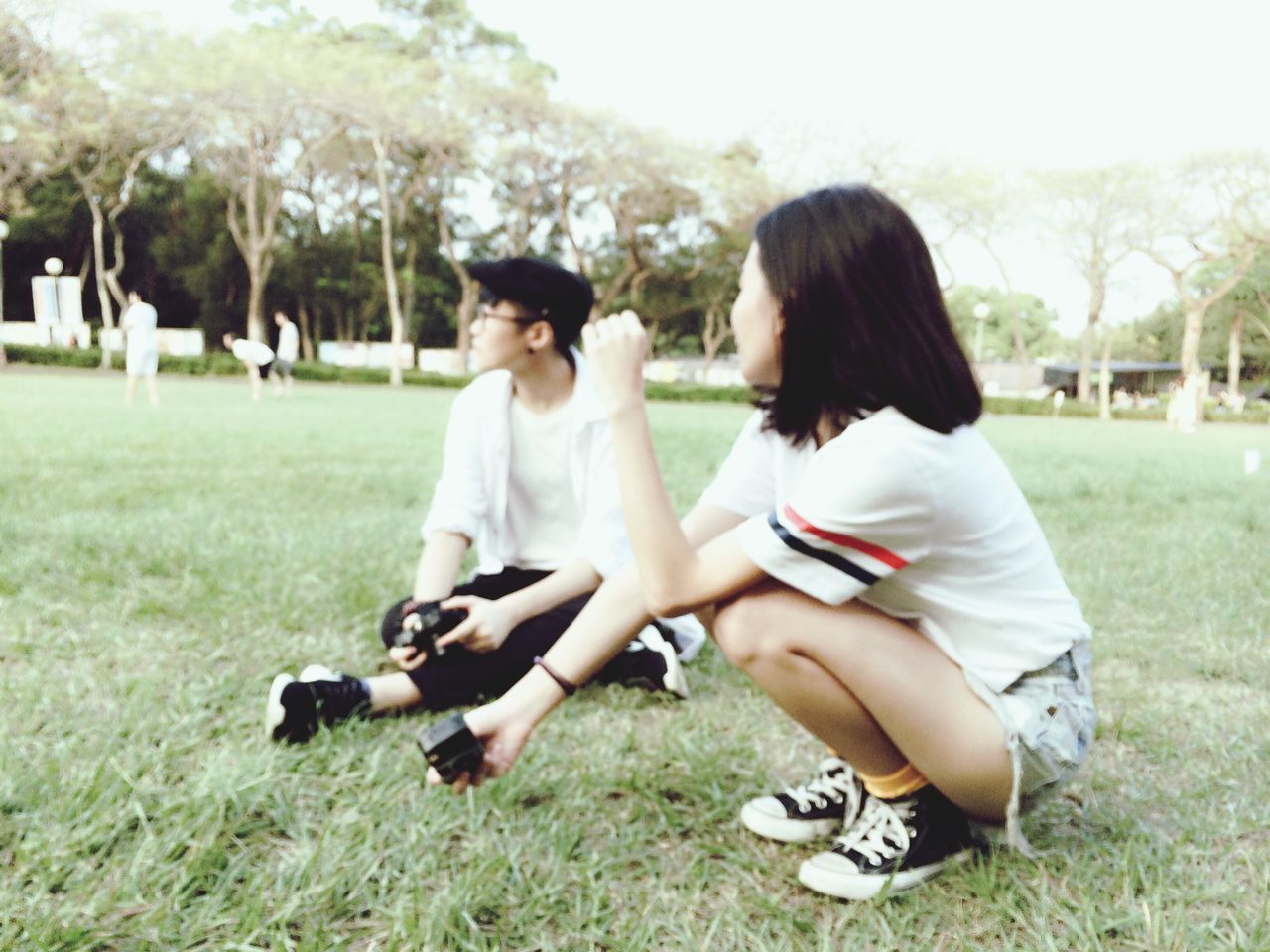 grass, lifestyles, leisure activity, park - man made space, tree, person, casual clothing, full length, togetherness, field, childhood, young women, grassy, girls, playing, park