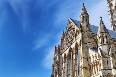 Low angle view of york minster against blue sky