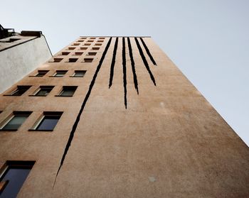 Low angle view of tall building against clear sky