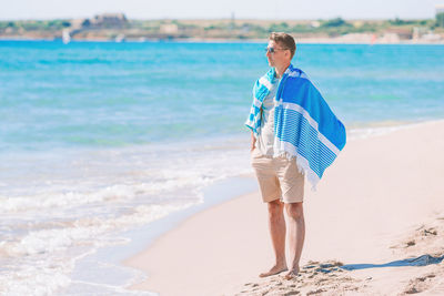 Full length of man standing on beach