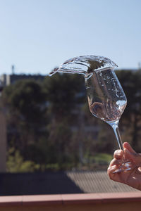 Close-up of hand holding glass of drink