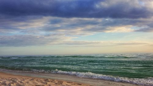 Scenic view of beach against sky during sunset