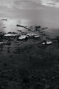 High angle view of boats on sea shore against sky