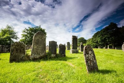 Old ruins in cemetery against sky