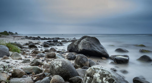 Rocks in sea against sky