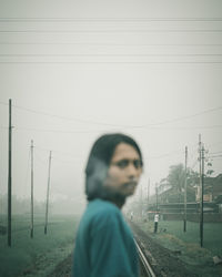 Man looking at camera against sky