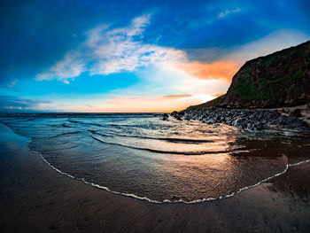 View of beach against cloudy sky