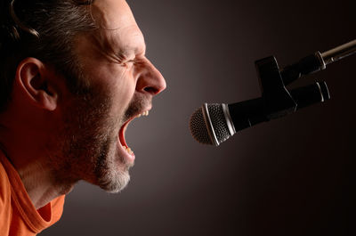 Side view of man against black background