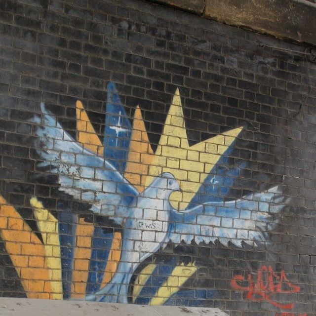 art and craft, architecture, wall - building feature, graffiti, text, built structure, art, brick wall, creativity, building exterior, western script, wall, pattern, communication, outdoors, day, human representation, no people, street art, mural