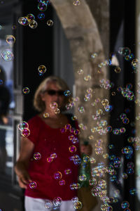 Close-up of bubbles with woman in background