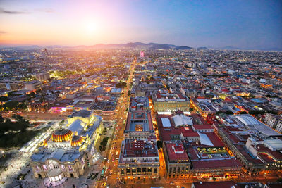 High angle view of city lit up at night