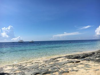 Scenic view of sea against blue sky