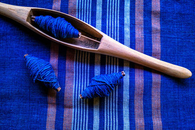 High angle view of paintbrushes on blue table