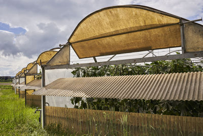 Built structure on field against sky