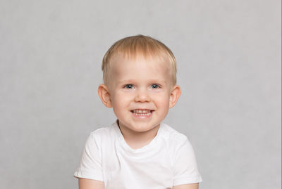 Portrait of smiling boy against white background