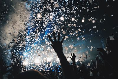 Crowd enjoying at music concert at night