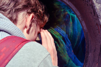 Close-up portrait of man with reflection on glass