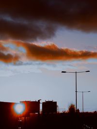 Low angle view of silhouette street light against sky at sunset