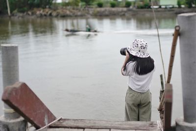 Rear view of woman in lake