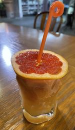 Close-up of orange and grapefruit juice on table