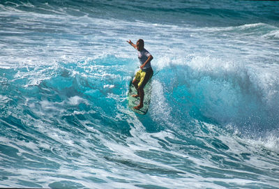 Full length of man surfing in sea