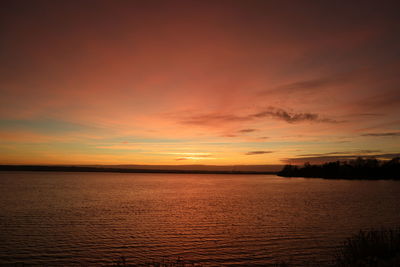 Scenic view of sea against orange sky