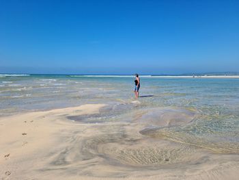 Man on beach against sky