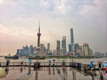 Skyscrapers against cloudy sky